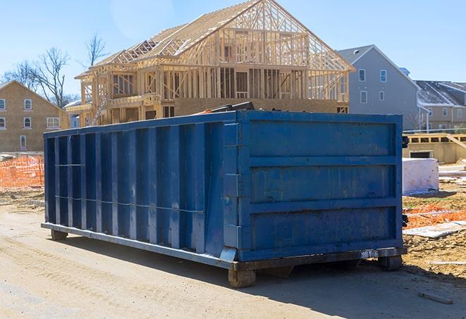 large metal containers in a rural dumpster rental lot